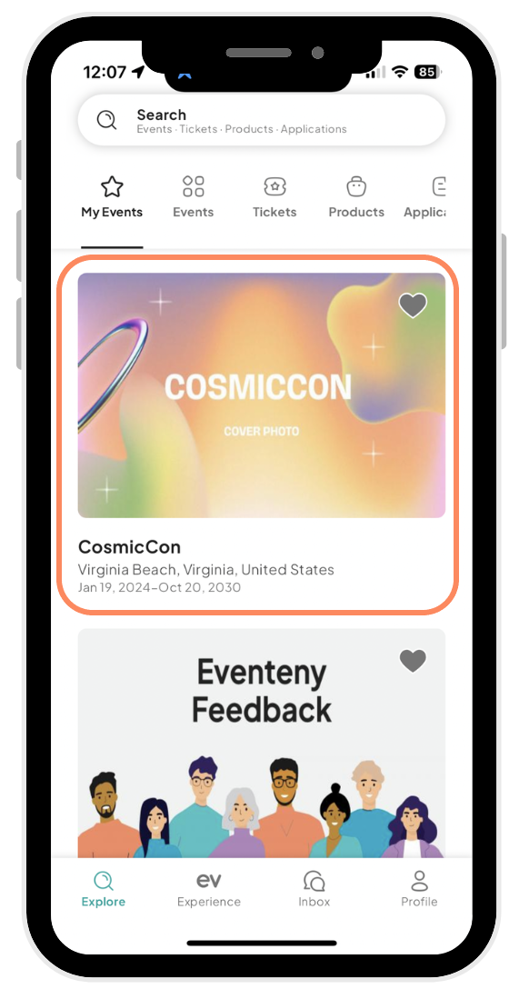 The image shows a mobile phone displaying an event management application. The screen highlights a section featuring an event titled CosmicCon, with a visually appealing cover photo, located in Virginia Beach, Virginia, United States, running from January 19, 2024, to October 20, 2030. Below the main event information, there is another card labeled Eventeny Feedback, showcasing a diverse group of illustrated people. The application includes navigation icons at the bottom for Explore, Experience, Inbox, and Profile, indicating different sections of the app. The user interface is modern and user-friendly, designed to enhance event browsing and management on a mobile device.